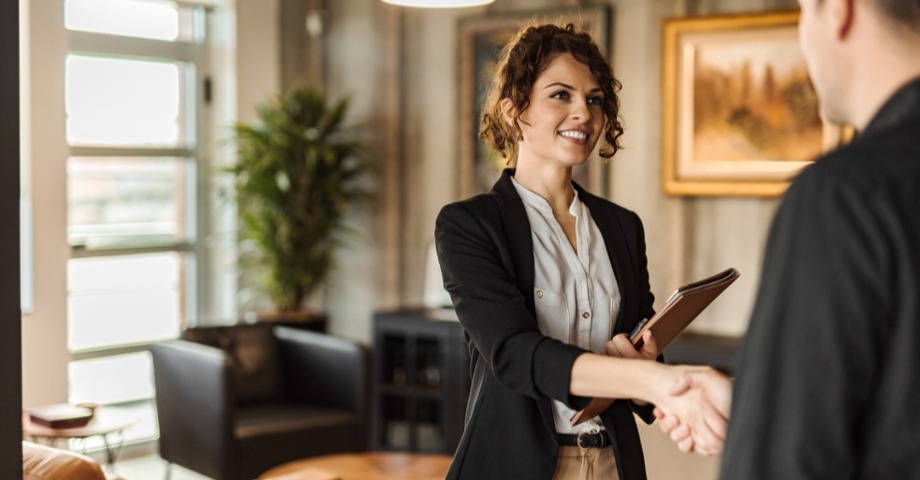 woman shaking hands with someone off screen