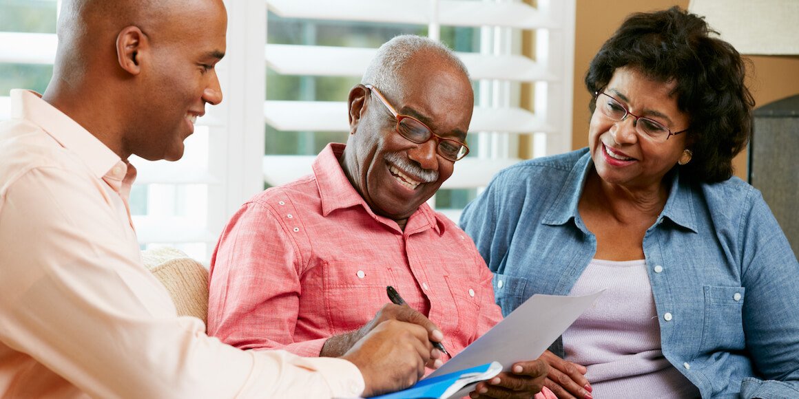 older gentleman signing paperwork