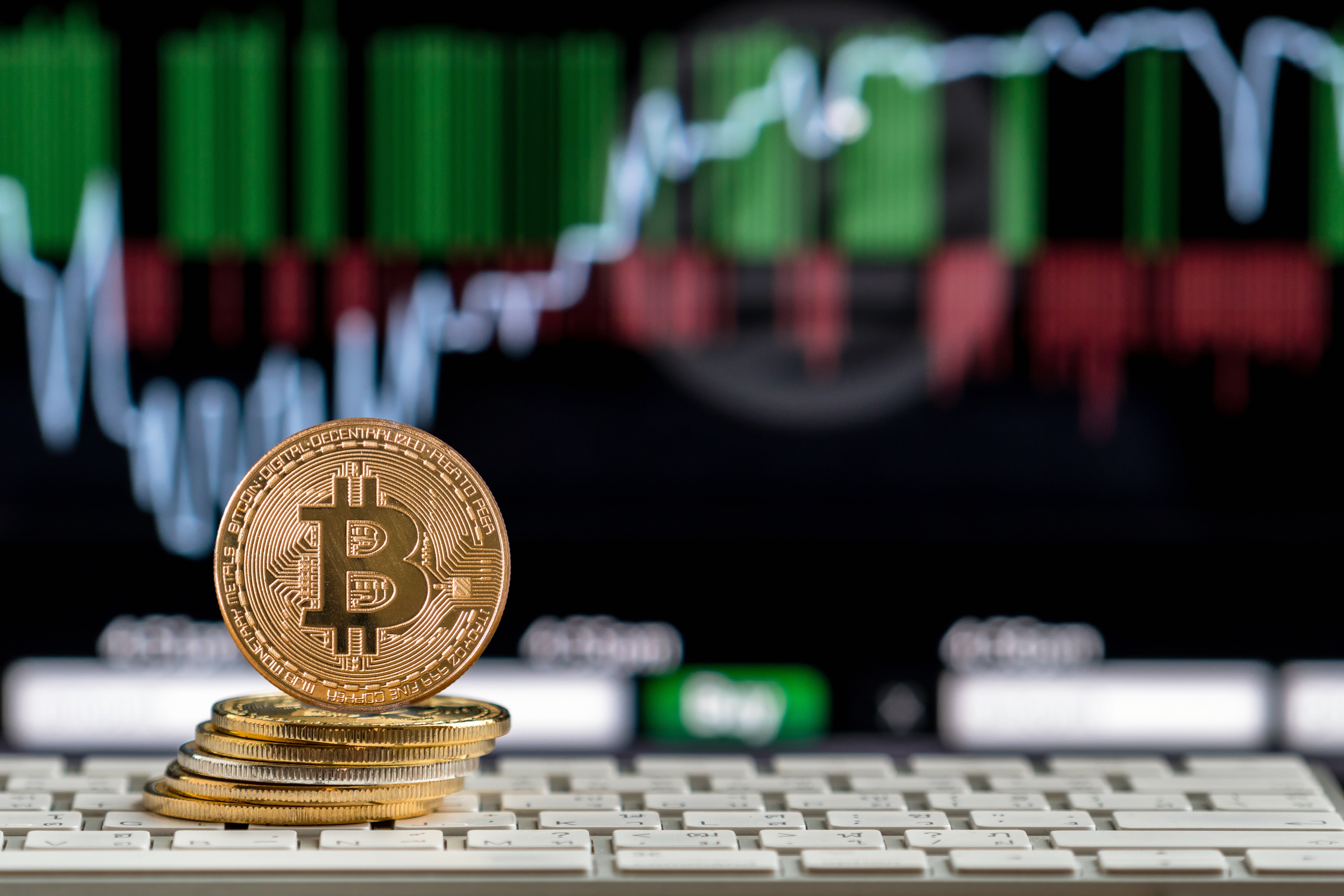 stack of bitcoins in front of a sign