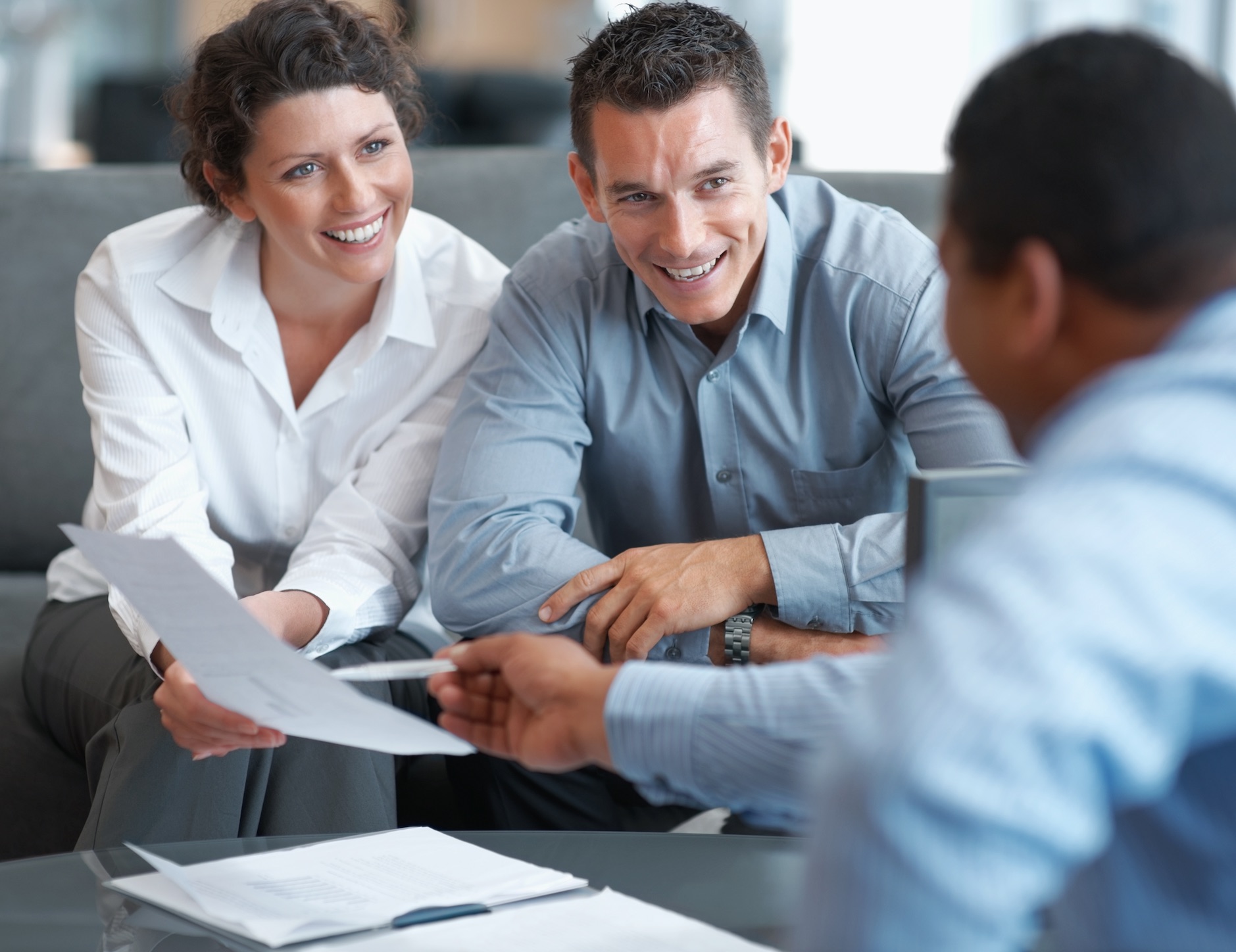 Man and woman looking over paperwork and smiling