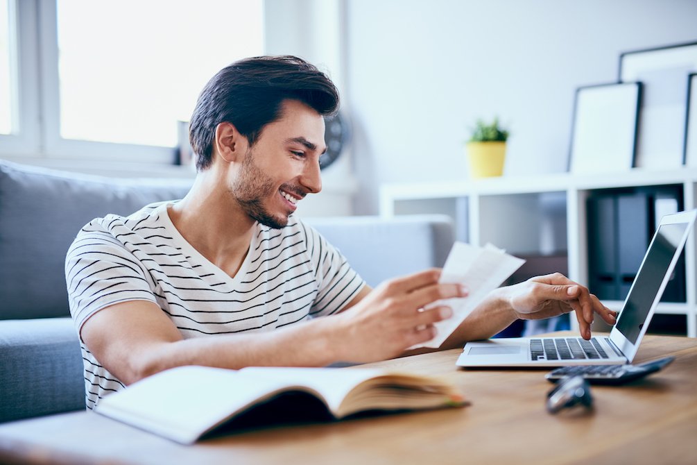 Man entering information into a laptop